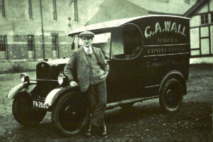 Charles Alfred Wall, baker of number 5 Friar Street, Worcester leaning against one of his bread-vans circa 1920