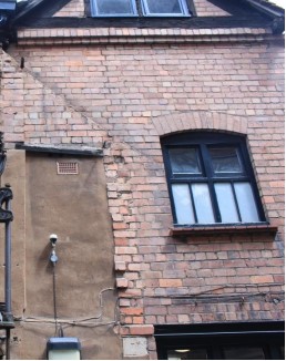 Shadow of a roofline indicating part of a lost wing to the rear of Tudor House