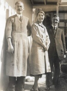 BertBrooks standing on the steps of 7 Lark Hill with Frank Ansell and Harriet Smith.